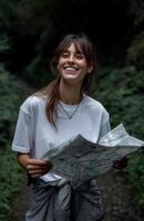 Smiling hiker explores forest trails while planning her next adventure with a map photo