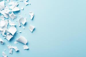 Shredded white paper on light blue background photo