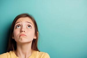 Girl looking up with a thoughtful expression photo