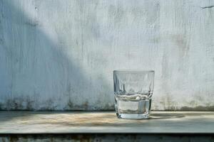 Water glass on a worn table photo