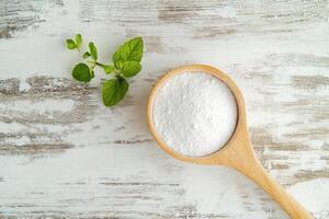 Baking ingredients on a wooden surface with herbs photo
