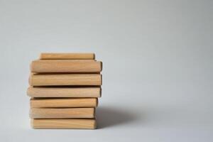 Wooden blocks stacked on a plain background photo