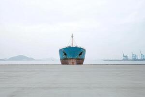 Ship docked at a quiet harbor on an overcast day photo