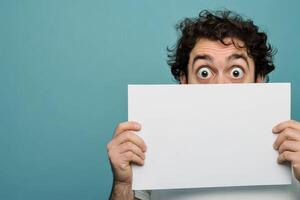 Surprised man with paper in playful pose photo