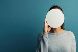 Woman with round object indoors photo