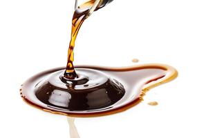 Melted liquid chocolate dripping from bottle on white surface in 4k high definition photo