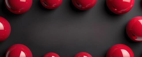 Red glossy spheres arranged on a dark matte surface forming a border with space in the center for text or design photo