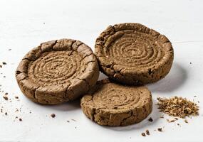 Group of holy cow dung cakes made from waste of cows stacked on each other and isolated on white background. High definition photography photo