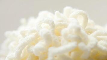 Close up of cream colored soft woven yarn texture with blurred background creating a cozy feeling photo