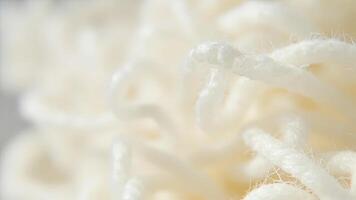 Delicate close up of soft cream colored yarn with focus on the textured threads photo