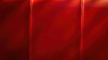 Close up red leather texture revealing detailed stitching and rich color variations photo