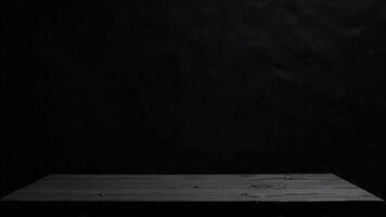 Minimalist dark wooden tabletop surface against black backdrop providing elegant design and product presentation space photo