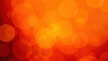 Warm orange bokeh background with bright circular shapes in various sizes creating a modern design aesthetic suitable for festive and abstract projects photo