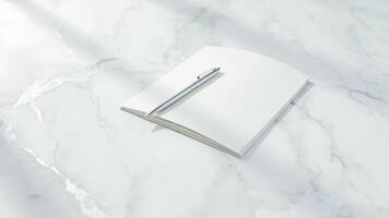 Elegant silver pen resting on blank white notebook pages on a marble surface photo