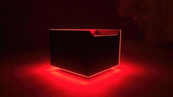 Illuminated geometric cube with red neon edges and ambient light on a dark background photo