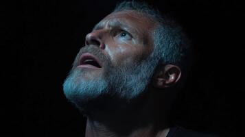 Man looking upward in fear. Close up, dramatic expression photo