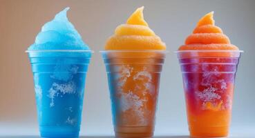 Three different colored ice cream in plastic cups photo