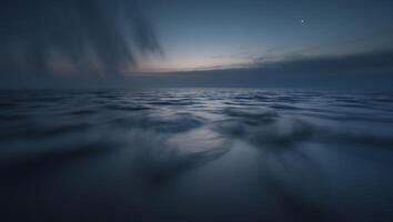 A long exposure photograph of the ocean at dusk photo
