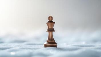 A small bronze chess piece on top of a white background photo