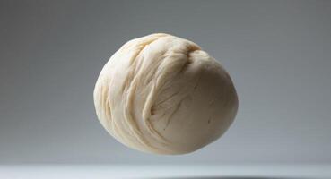 Ball of Freshly Prepared Dough, Suspended in Air, Ready for Baking, Isolated. photo