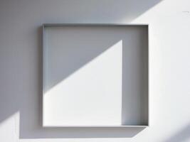 A white wall with a square frame on it photo