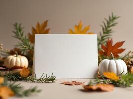 Autumnal Still Life with Blank Card, Pumpkins, and Colorful Leaves in Warm Tones photo