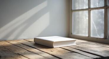 White Book on Rustic Wooden Table Near Window with Sunlight, Study and Literature. photo
