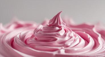 A close up of a pink frosting on top of a cake photo