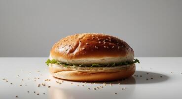 Simple yet delicious burger with sesame bun and fresh lettuce on a white surface. photo