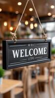A welcome sign hanging from a wooden frame in a restaurant photo