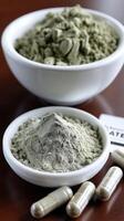 A bowl of green powder and a small white bowl photo