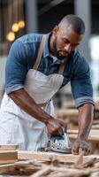 A man in an apron is working on a wooden table photo