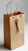 Brown paper bag with rope on white background photo