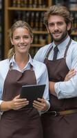 A man and woman in aprons standing in front of a store photo