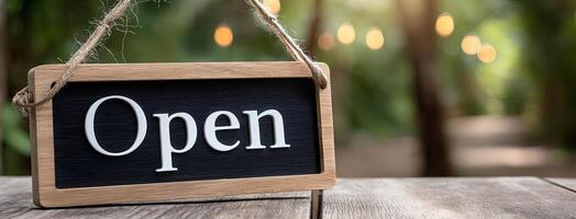 Open sign hanging on wooden table photo