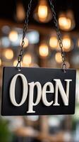 Open sign hanging from a chain in a restaurant photo