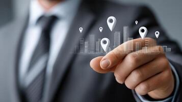 Businessman pointing to city map icons on business card photo