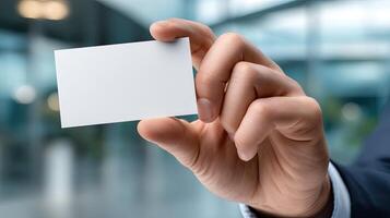 A person holding a blank business card photo