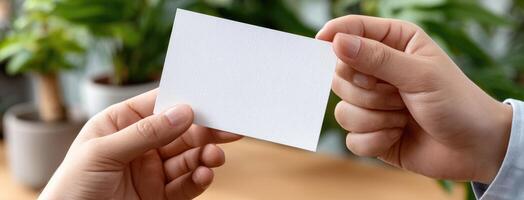 Two hands holding a blank piece of paper photo