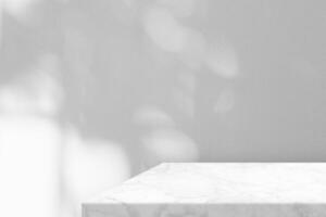 Minimal White Marble Table Corner with Light Beam, Shadow, and Bokeh on Concrete Wall Background photo