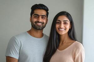 A young couple smiling and posing for the camera. photo