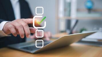 Businessman tick correct mark to approve document or project checklist, Application for certificate, Quality management and assurance, Business certification, Pass inspection, Accept approved, QA, QC photo