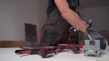 Man using cordless drill with gloves in workshop video