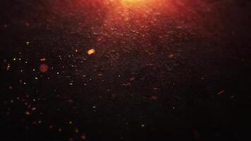 Glowing embers on a dark surface create an atmospheric background video