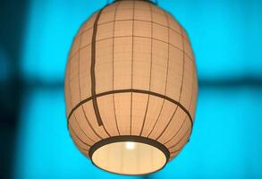 white lamp hanging from a ceiling in a room photo