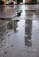 wet street with a clock tower in the background photo