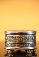 metal container sitting on top of a wooden table photo