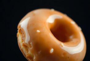 close up of a glazed donut with icing photo