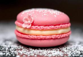 pink macaroon with a flower on top of it photo