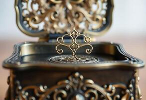 gold and black metal object on a table photo